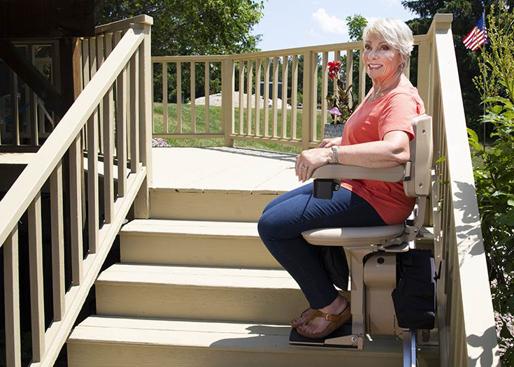 woman riding outdoor stair lift