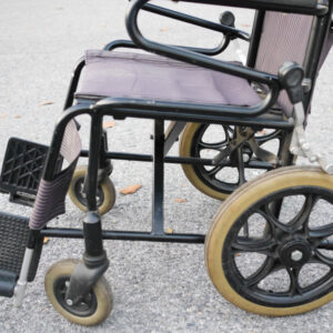 Empty old wheelchair in the park. Medical concept.