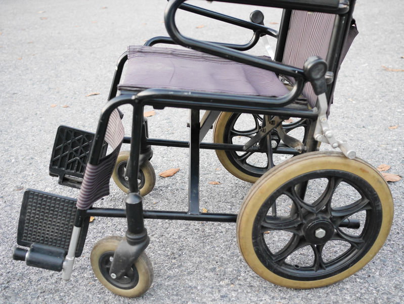 Empty old wheelchair in the park. Medical concept.